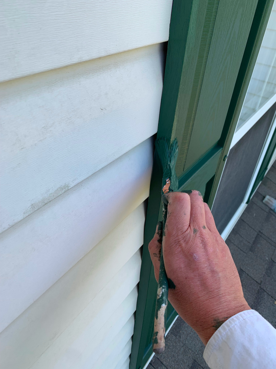 Precision brush painting in Ruckersville VA with a hand cut edge and minimal green paint on siding