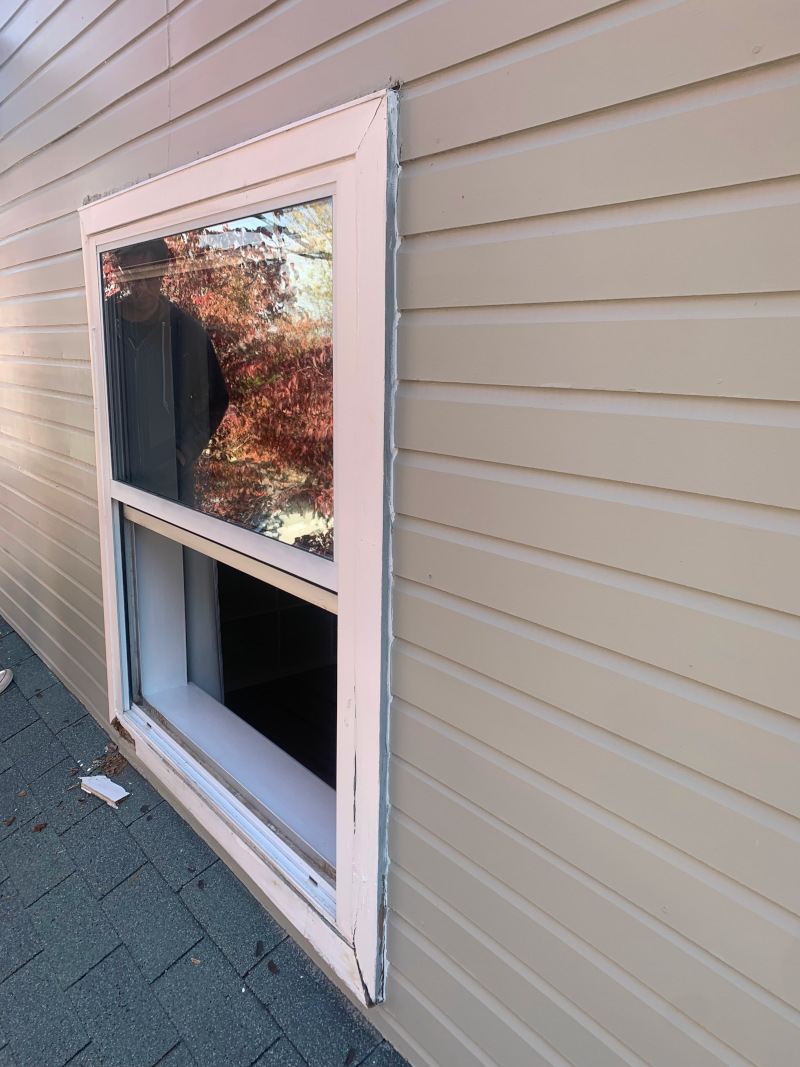 Rotted window trim and deteriorated siding