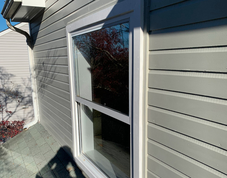 Completed exterior window trim repair with new HardieBoard and MiraTEC trim