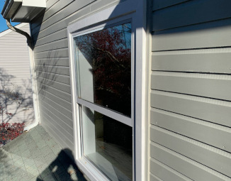 Completed exterior window trim repair with new HardieBoard and MiraTEC trim