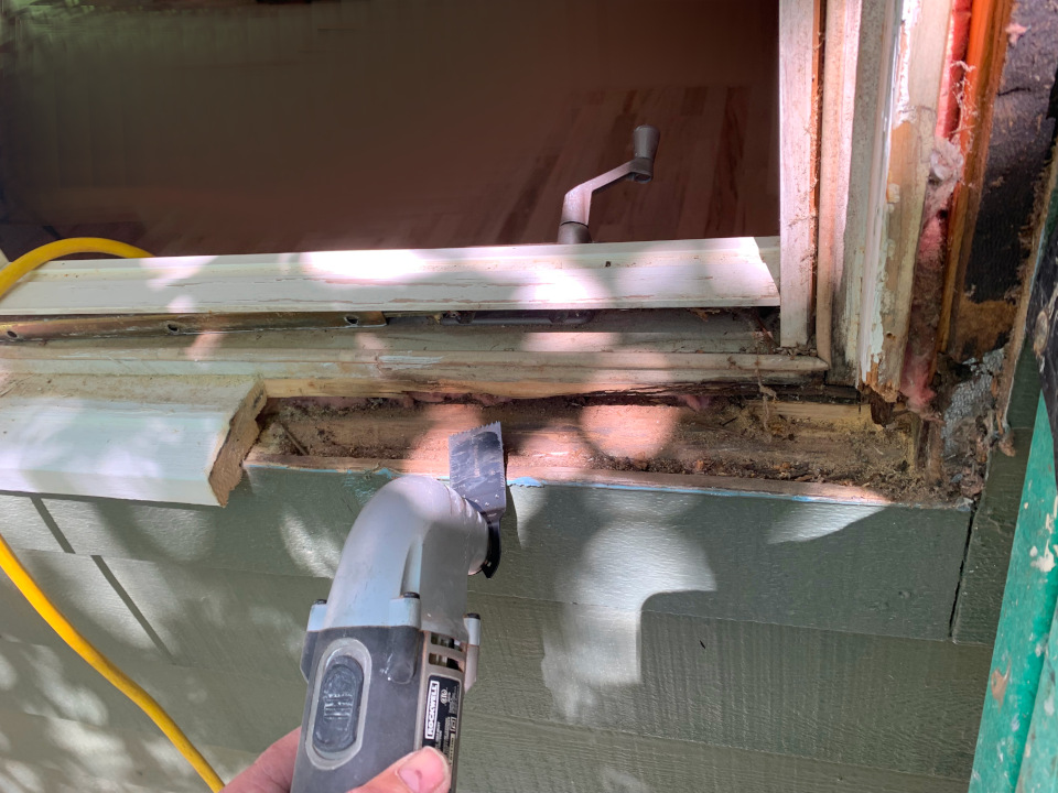 Cutting out the damaged frame material using an oscillating tool.