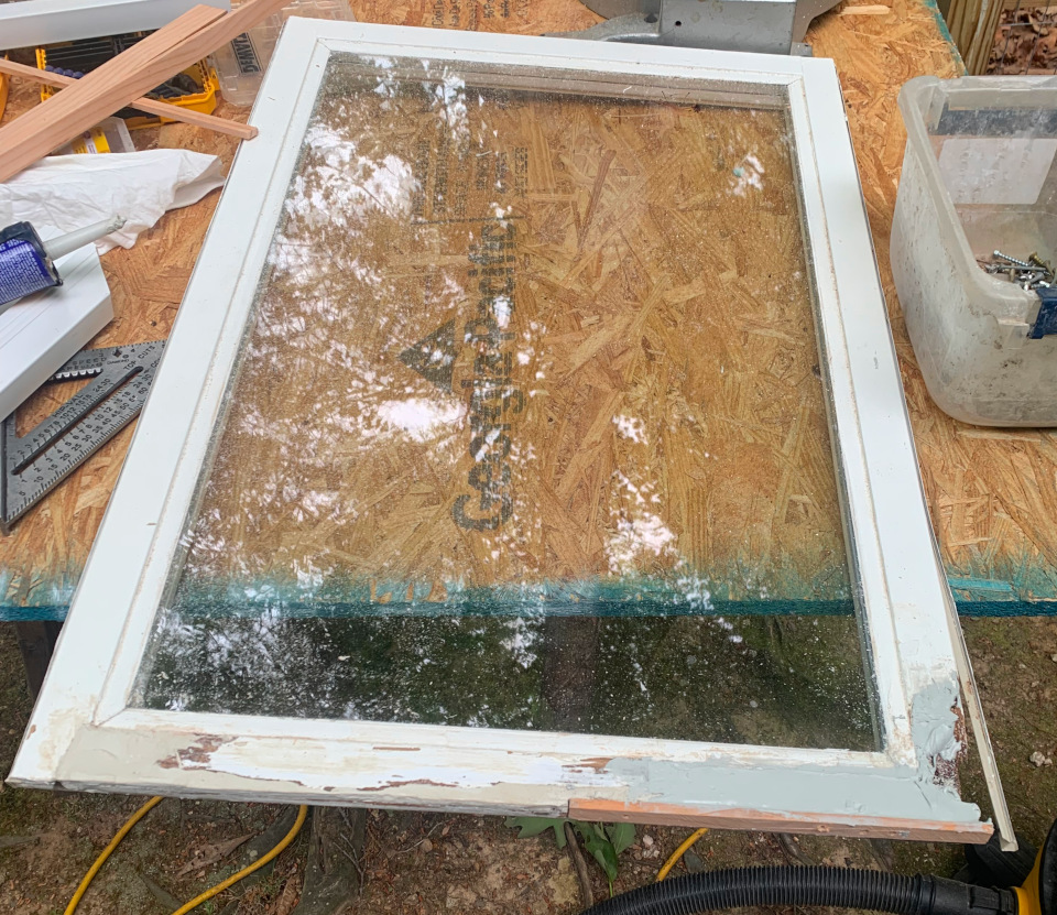 The sash partially rebuilt using a combination of wood and Bondo, restoring the missing profiles and preparing it for final shaping.
