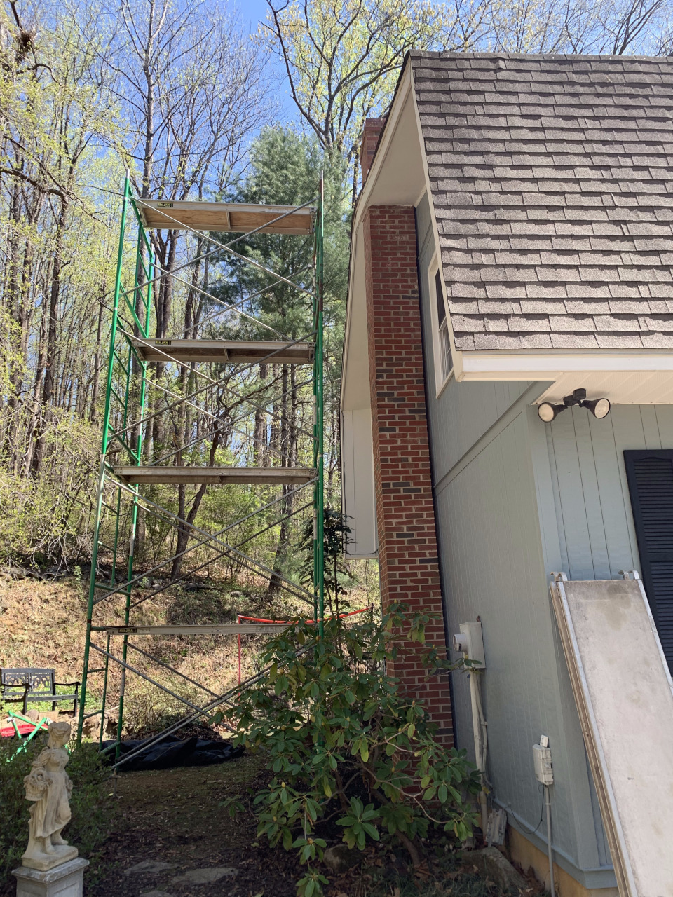Scaffolding is set up beside the chimney to provide safe access for restoration.