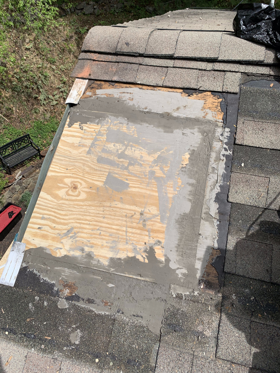 The gaps between the new sheathing section and the existing roof sheathing have been leveled to create a flat surface.