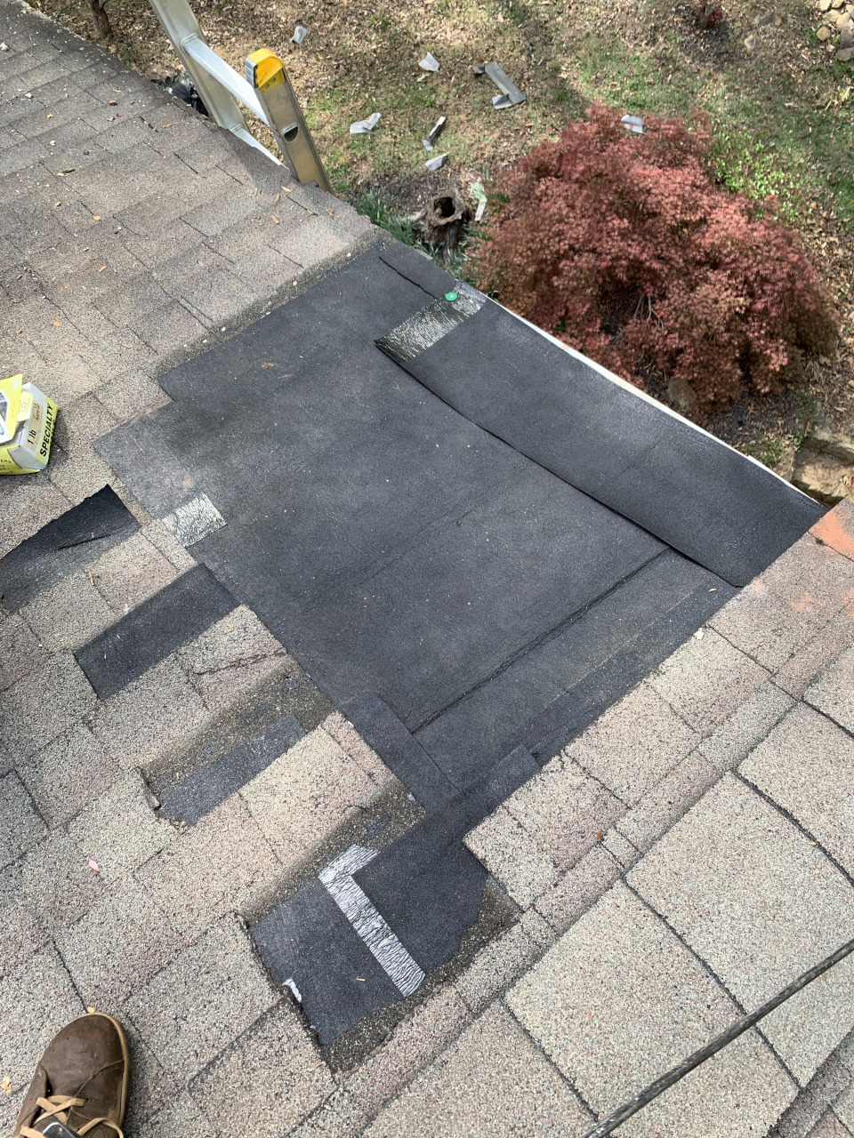 A peel-and-stick asphalt underlayment has been installed over the new sheathing section.