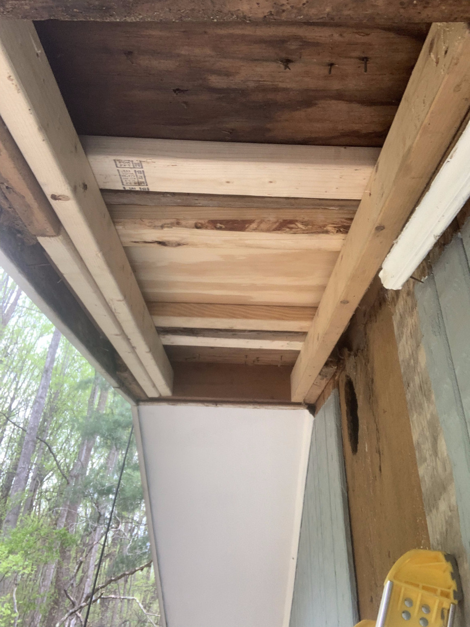 New framing has been installed to stabilize the rotted sections within the soffit.