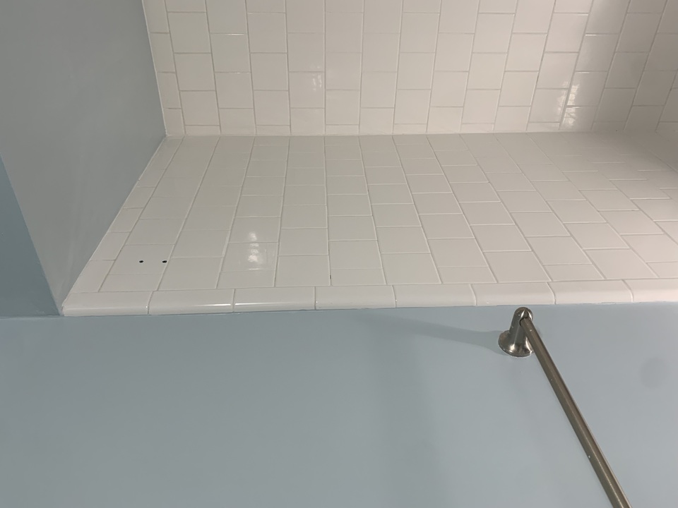 Repaired wall after painting, patches blended into surrounding surface.